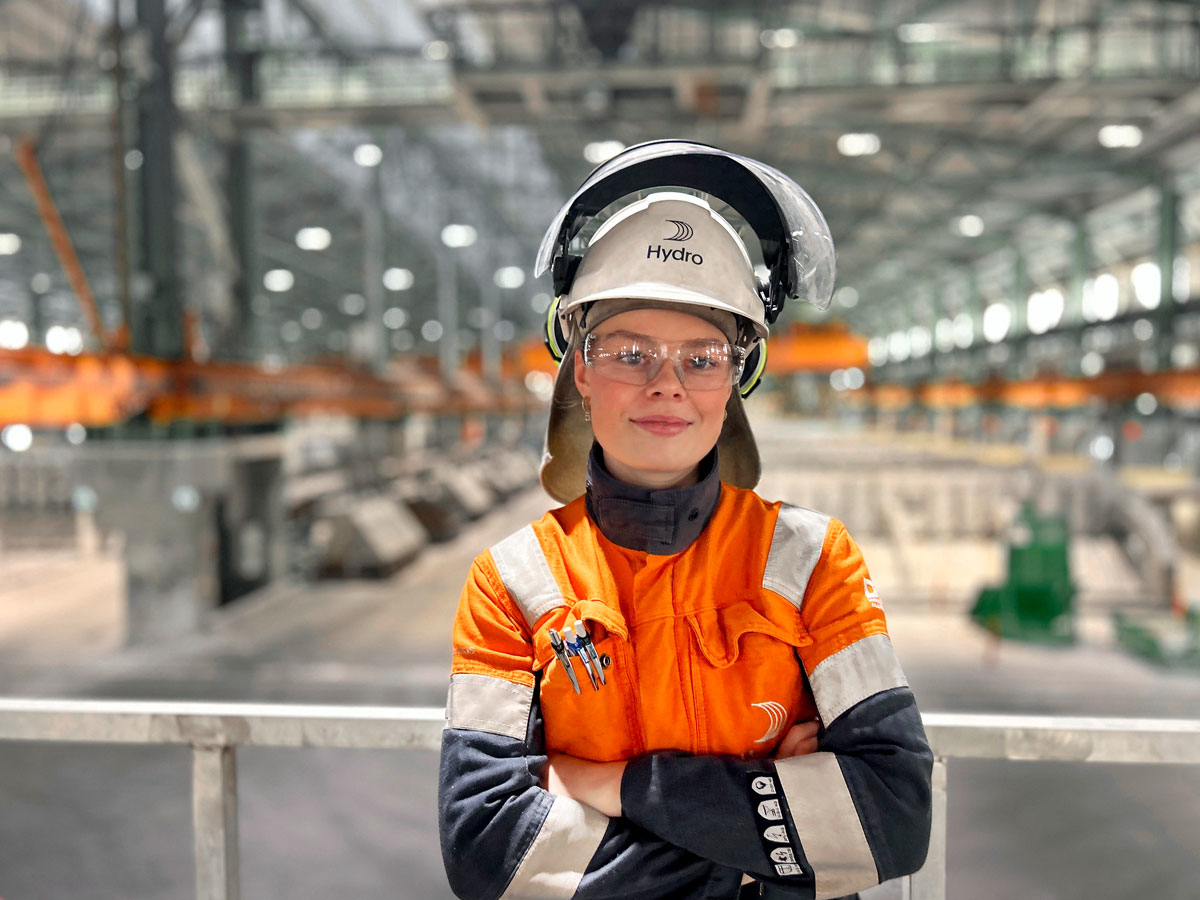 Photo of a woman wearing work clothes and a helmet labelled Hydro.