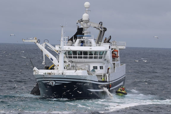 Figure 5.2 Fishing vessel during fishing operations, showing Coast Guard personnel boarding for inspection.