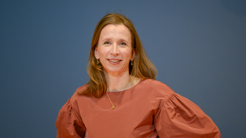 Justis- og beredskapsminister Astri Aas-Hansen (Ap). Foto: Magnus Skaara Drabløs/Kommunal- og distriktsdepartementet Portrett av kvinne i rød topp som ser i kamera